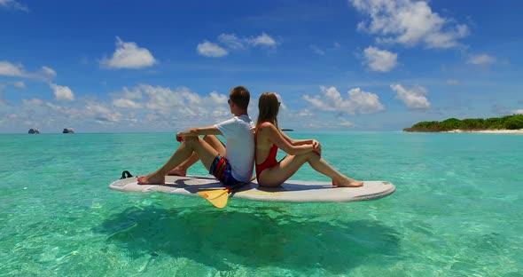 Beautiful man and woman on romantic honeymoon live the dream on beach on summer white sandy 4K backgrund