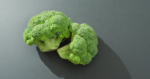 Video of fresh broccoli florets with copy space on grey background