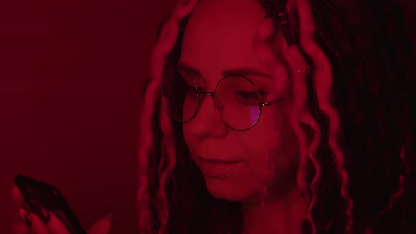 Close Up of Glasses on Woman with Reflection of Cell Phone Screen