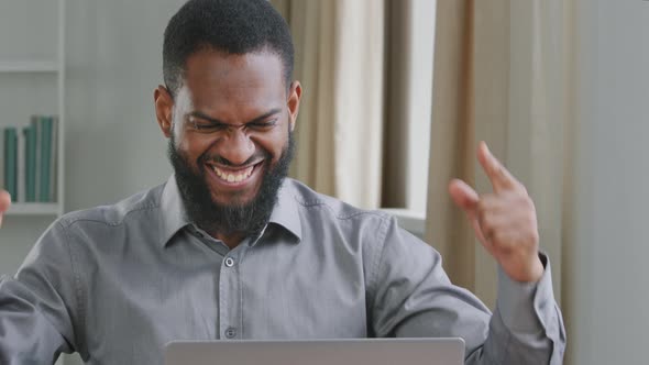 Overjoyed African Bearded Businessman in Formal Wear Looking at Laptop Screen Excited By