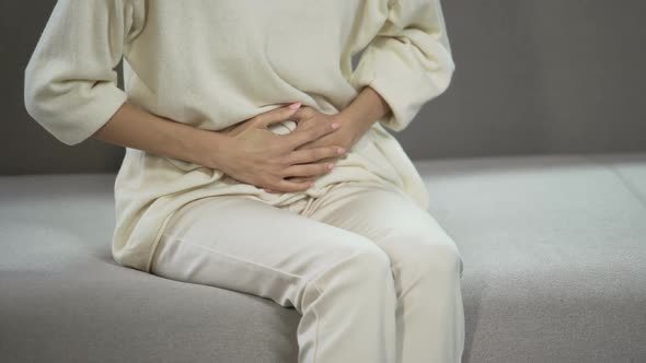 Young Woman Suffering From Strong Menstrual or Stomach Ache, Gynecology Problems