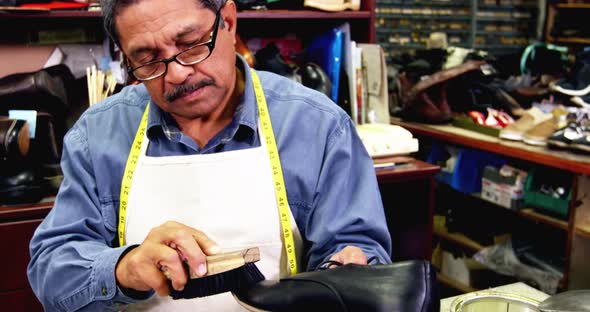 Cobbler polishing a shoe