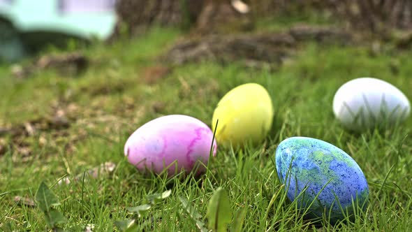 Adding and arranging  multi colored colored  Easter eggs in green grass