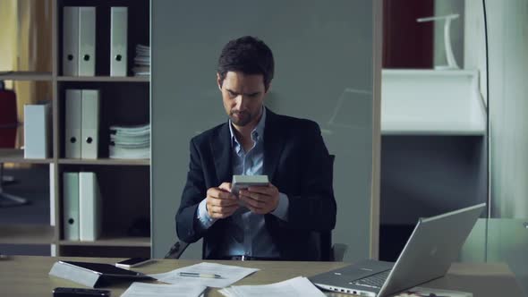 Businessman using calculator