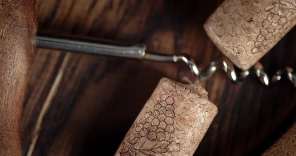 Corks and Corkscrew on a Wooden Barrel. Macro Background. 