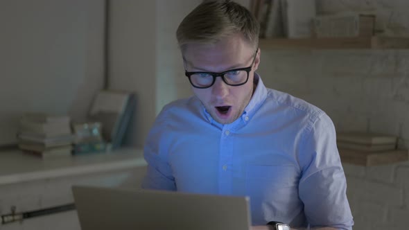 Businessman Getting Shocked While Working on Laptop