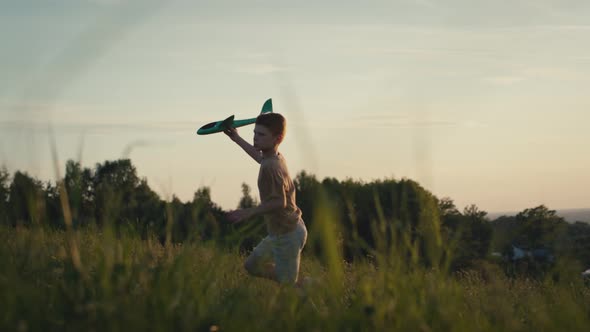 Little boy running with toy airplane at meadow. Shot with RED helium camera in 4K.