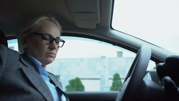 Upset Woman Leaning on Steering Wheel and Crying, Professional Burn-Out, Pms
