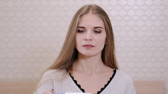 Worried Girl After Looking at Pregnancy Test at Home