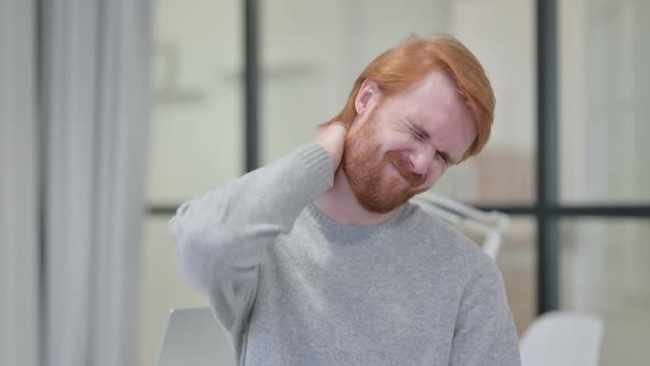 Portrait of Young Redhead Man Having Neck Pain