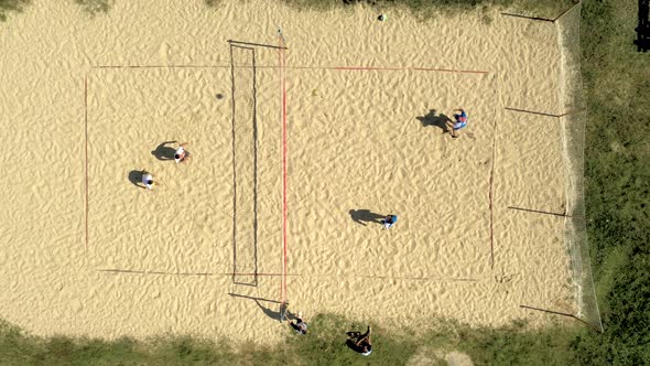 No players identified in action during to plaing Volleyball. Aerial shot.