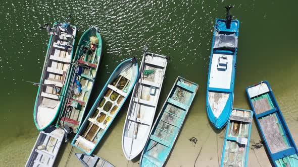 Aerial view looking straight down and camera showing small wooden fishing boats in a harbor in Mexic