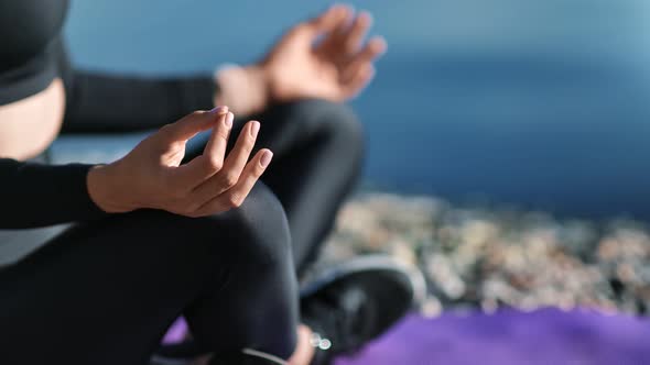 Close Up Female Hands Practicing Morning Yoga on Beach