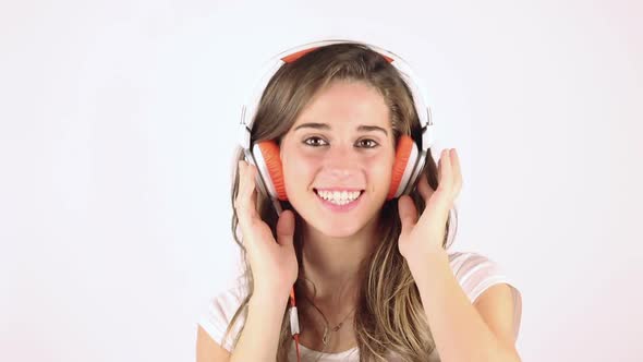 Happy Young Woman Listening Music with Headphones