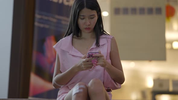 The Girl is Sadly Chatting on Her Mobile and Looking at the Sky to See If It is Raining