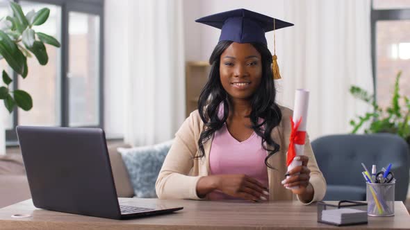 Graduate Student with Laptop and Diploma at Home