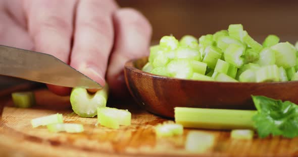 Men Hands Cut with a Knife the Celery