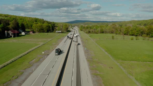 Aerial Drone View of Flight Over the Highway with Many Cars and Trucks