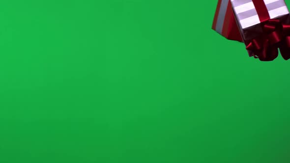 Falling presents against green screen, Slow Motion