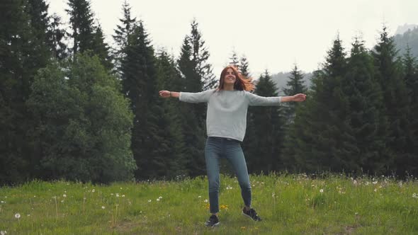 Slow Motion Shot of Happy Young Woman Spinning and Running in the Dolomites Northern Italy in the