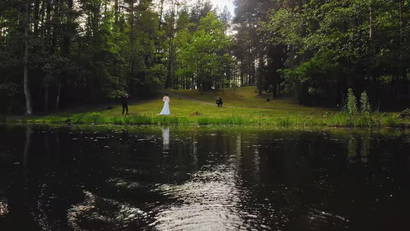 Cinematic View Couple By Lake On Photoshoot