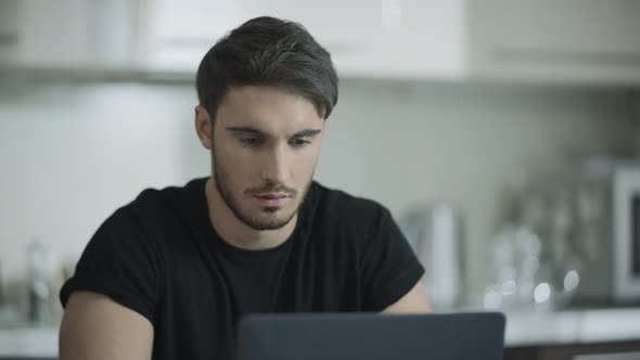 Business Man Face Working Laptop Computer at Home. Businessman Using Computer