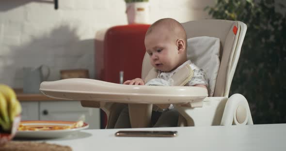 Baby Playing in a High Chair