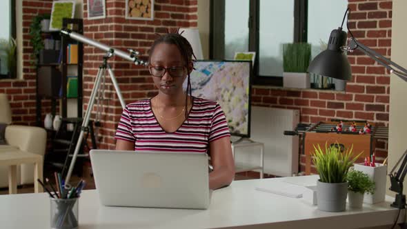 Portrait of African American Woman Attending Online Webinar