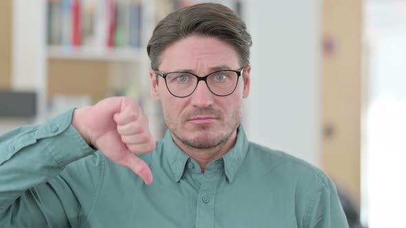 Middle Aged Man Showing Thumbs Down Sign