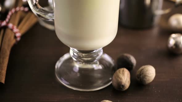 Traditional holiday drink egg nog garnished with nutmeg.