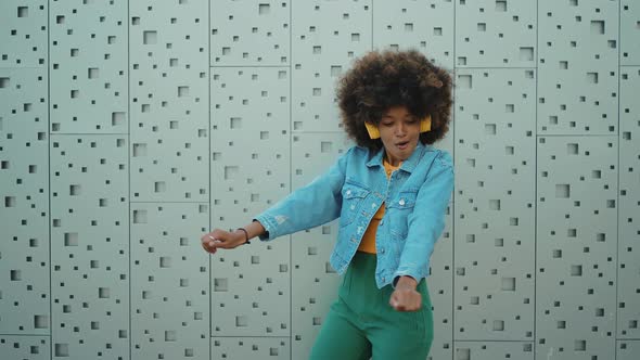 Beautiful young woman with curly hairstyle and fashionable clothes