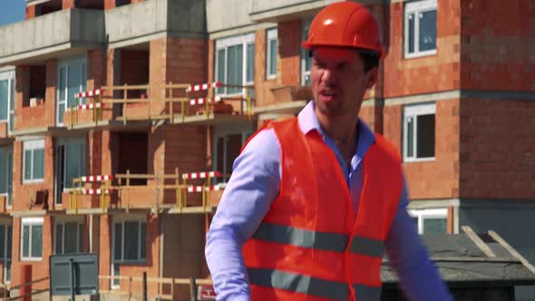 Construction Worker Is Angry and Shouts in Front of Building Site