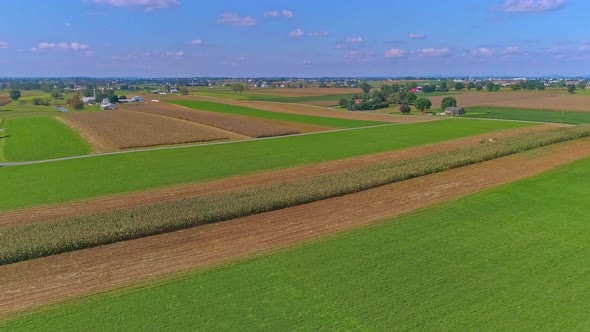 Aerial View of Rural America of Amish Farmlands With Amish Harvesting the Crops