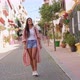 Stylish Smiling Hispanic Woman Walking Along City Street - VideoHive Item for Sale