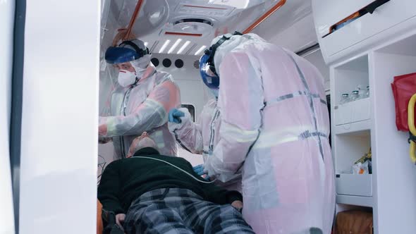 Emergency Medicine Workers with Patient in Ambulance