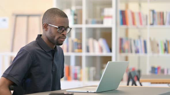 Serious African Man Closing Laptop and Going Away