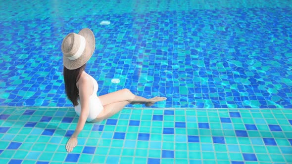 Young asian woman enjoy around outdoor swimming pool for leisure