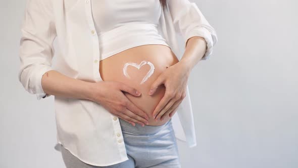 Pregnant Woman Posing in Studio, Being in Anticipation of Baby.