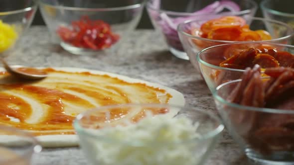 Spreading Tomato Sauce with Spoon