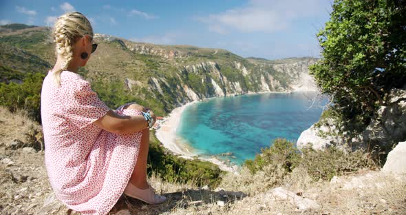 Woman Traveller on Top of Mountain Looking at Beautiful Sea Bay Celebrating Scenic Landscape