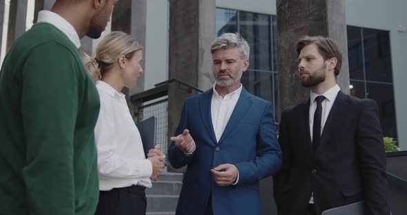 Business People Discussing Near Office On Street