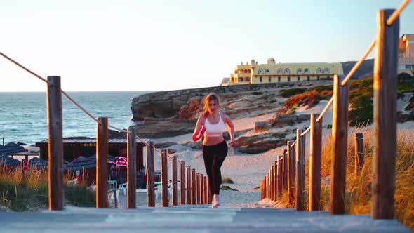 Athletic Sportswoman Running on Beach Wooden Stairs Path Slow Motion