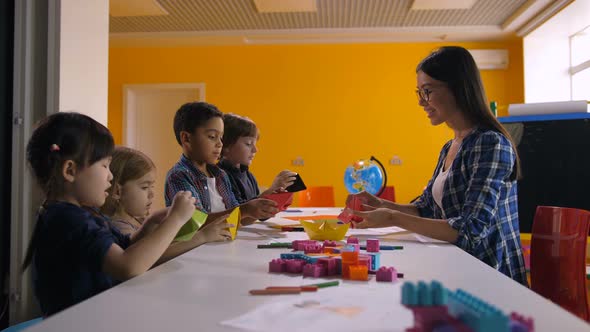 Multicultural Kids Making Ship with Colored Paper