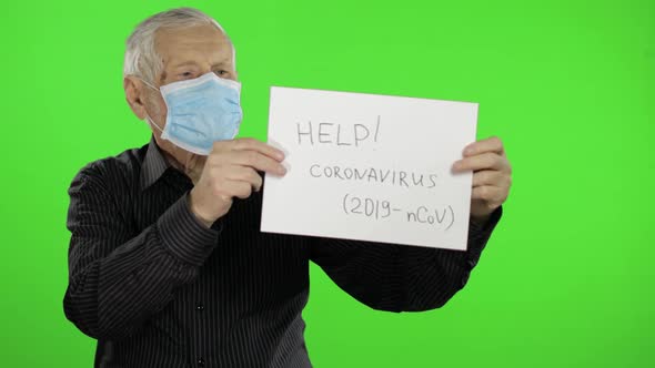 Elderly Grandfather Man in Medical Mask Show Page with Message. Coronavirus