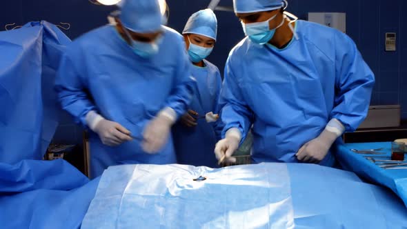 Surgeons performing operation in operation room