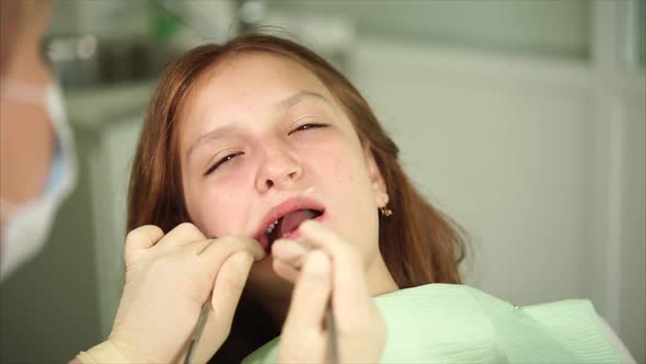 Orthodon Checks the Teeth of a Teenager Who Has Come to the Clinic for Treatment