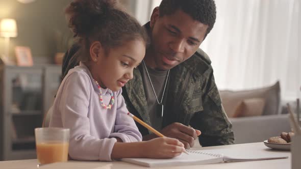 Dad and Little Girl Doing Homework Together alt