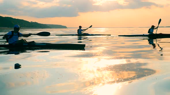 Sunset Waters and Paddlers Drifting Along Them