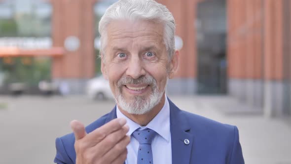 Old Businessman Inviting New People While Standing Outdoor