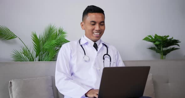 Doctor talking to patient making video call on laptop